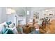 Bright living room with fireplace, an eye-catching mirror, and an open flow into the dining area at 3613 Julian St, Denver, CO 80211