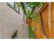 Narrow side yard with pathway, low fence and view of the home at 3613 Julian St, Denver, CO 80211