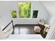 Cozy landing with ample natural light, a sitting area, and views of the surrounding foliage through the windows at 3613 Julian St, Denver, CO 80211