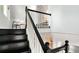 Staircase with dark wood steps and white risers leading to the upper level, complemented by white railing at 3613 Julian St, Denver, CO 80211