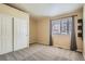 Bright bedroom with large windows, closet, and neutral carpet creating a calm and inviting atmosphere at 10507 W Maplewood Dr # E, Littleton, CO 80127