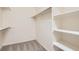Spacious walk-in closet with carpeting, shelves, and hanging rods, providing ample storage at 10507 W Maplewood Dr # E, Littleton, CO 80127