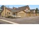 Charming townhouse exterior with manicured landscaping, inviting curb appeal and attached garages at 10507 W Maplewood Dr # E, Littleton, CO 80127
