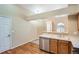 This kitchen features wood floors, stainless steel appliances, and an undermount sink at 10507 W Maplewood Dr # E, Littleton, CO 80127
