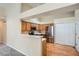 Updated kitchen with stainless steel appliances, wood cabinets and hardwood floors, open to living spaces at 10507 W Maplewood Dr # E, Littleton, CO 80127