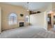 Bright living room with high ceilings, fireplace, arched windows and plush neutral carpet at 10507 W Maplewood Dr # E, Littleton, CO 80127