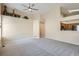 Open living area with neutral decor, ceiling fan and smooth carpeting, ready for personal touches at 10507 W Maplewood Dr # E, Littleton, CO 80127