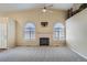 Warm and inviting living room with a fireplace and arched windows, perfect for cozy gatherings at 10507 W Maplewood Dr # E, Littleton, CO 80127