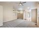 Bright and spacious living area that features a fireplace, plush carpeting and a ceiling fan at 10507 W Maplewood Dr # E, Littleton, CO 80127