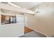 Open-concept room featuring updated floors and modern light fixture at 10507 W Maplewood Dr # E, Littleton, CO 80127