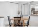 Cozy dining area features a round wooden table and black spindle chairs, perfect for intimate meals at 12478 W Nevada Pl # 208, Lakewood, CO 80228