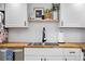 Bright kitchen featuring butcher block countertops, white subway tile, and a stainless steel sink at 12478 W Nevada Pl # 208, Lakewood, CO 80228