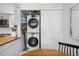 Efficient laundry closet with stacked washer and dryer, located off the kitchen for convenience at 12478 W Nevada Pl # 208, Lakewood, CO 80228