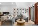 Comfortable living room featuring a gray sectional sofa, wood floors, and bright, natural light at 12478 W Nevada Pl # 208, Lakewood, CO 80228