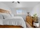 Bright main bedroom featuring skylight, light hardwood floors, and natural wood furniture accents at 12478 W Nevada Pl # 208, Lakewood, CO 80228