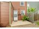Charming townhouse entrance with a cozy patio and neutral exterior with green landscaping at 1653 S Blackhawk Way # B, Aurora, CO 80012