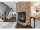 Inviting fireplace with stone surround, complemented by a staircase and open floor plan at 1653 S Blackhawk Way # B, Aurora, CO 80012