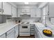 Bright kitchen features white cabinets, countertops, updated appliances and wood flooring at 1653 S Blackhawk Way # B, Aurora, CO 80012
