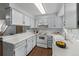 Bright kitchen features white cabinets, countertops, updated appliances and wood flooring at 1653 S Blackhawk Way # B, Aurora, CO 80012