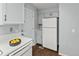 Kitchen features white countertops and appliances with wood flooring at 1653 S Blackhawk Way # B, Aurora, CO 80012