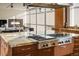 Modern kitchen island with granite countertops and a Wolf gas cooktop at 825 Circle Dr, Boulder, CO 80302