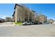 Multi-story building featuring meticulously maintained lawns, mature trees, and available parking spaces at 805 29Th St # 308, Boulder, CO 80303