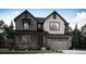 Charming two-story home featuring a two-car garage, covered porch, and beautifully landscaped yard at 7386 S Yank Ct, Littleton, CO 80127