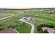 Beautiful aerial view of a house with a long driveway, surrounded by lush greenery and a golf course at 19887 Kershaw Ct, Monument, CO 80132