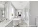 Bright bathroom with marble floors, double vanity, soaking tub, separate shower, and golf course views at 19887 Kershaw Ct, Monument, CO 80132