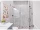 Modern bathroom showcasing a glass-enclosed shower with tiled walls, decorative wall art, and elegant fixtures at 19887 Kershaw Ct, Monument, CO 80132
