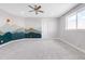 Spacious bedroom featuring carpeted floors, neutral paint, decorative wall art, and a ceiling fan at 19887 Kershaw Ct, Monument, CO 80132