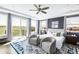 Bright main bedroom with a sitting area, ceiling fan, and private balcony with views at 19887 Kershaw Ct, Monument, CO 80132