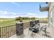 Outdoor deck with stone pillars, a fire pit, seating, and an expansive view of the golf course at 19887 Kershaw Ct, Monument, CO 80132