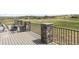 Outdoor deck with stone pillars, a fire pit, and an expansive view at 19887 Kershaw Ct, Monument, CO 80132