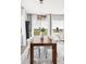 Dining room with long wood table, seating for ten, modern chandelier, and views of the golf course at 19887 Kershaw Ct, Monument, CO 80132