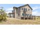 Attractive two-story home with a stone base, multiple balconies, large windows, and well-maintained landscaping at 19887 Kershaw Ct, Monument, CO 80132
