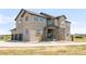 Stunning exterior elevation featuring a stone-accented entrance and three-car garage at 19887 Kershaw Ct, Monument, CO 80132