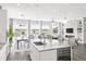 Bright, open kitchen with marble counters, island with wine fridge, and views of the golf course at 19887 Kershaw Ct, Monument, CO 80132