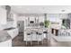Modern kitchen with white cabinets, stainless steel appliances, and a large central island with seating at 19887 Kershaw Ct, Monument, CO 80132
