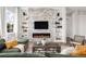 Inviting living room with a modern electric fireplace, built-in shelving, and comfortable seating at 19887 Kershaw Ct, Monument, CO 80132