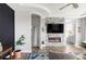 Contemporary living room with fireplace, flatscreen TV, gray stone accent wall and luxury vinyl plank flooring at 19887 Kershaw Ct, Monument, CO 80132