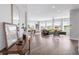 Expansive open-concept living area with hardwood floors, a ceiling fan, and beautiful natural light at 19887 Kershaw Ct, Monument, CO 80132