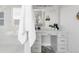 Bright bathroom vanity with marble countertop, seating area, vessel sink, decorative mirror and mosaic tile at 19887 Kershaw Ct, Monument, CO 80132