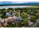 This aerial view shows the neighborhood, surrounding greenery, and a lake in the background at 3142 Captains Ln, Longmont, CO 80503