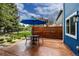 This backyard patio has a table with four chairs, a blue umbrella and a wooden fence for privacy at 3142 Captains Ln, Longmont, CO 80503