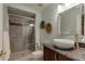 Stylish bathroom featuring a glass-enclosed shower, decorative sink, granite countertop, and modern fixtures at 3142 Captains Ln, Longmont, CO 80503