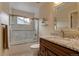 This bathroom features a shower and bath combination, neutral tile, a granite countertop and lots of storage at 3142 Captains Ln, Longmont, CO 80503