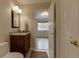 This bathroom features a granite countertop with a dark wood vanity, neutral paint and a decorative mirror at 3142 Captains Ln, Longmont, CO 80503