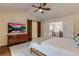 Bright bedroom offers wood floors, ceiling fan, TV, dresser, barn doors, and open access to the upstairs hallway at 3142 Captains Ln, Longmont, CO 80503