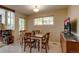Cozy dining area features natural light from two windows, a wood table with seating for four, and modern decor at 3142 Captains Ln, Longmont, CO 80503
